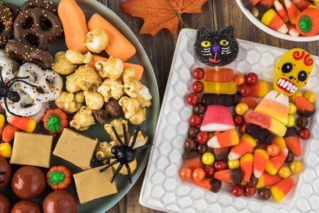 Close up of plate with Halloween assorted candies on a wooden background.の写真素材