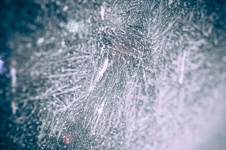 Christmas background with lights through frost coveredwindow.の写真素材