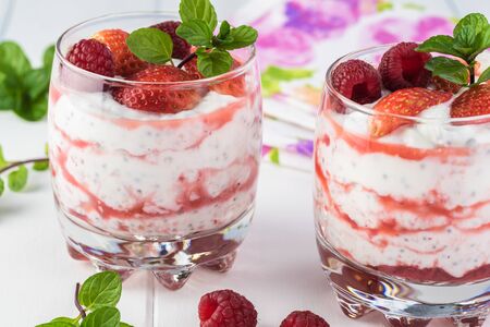 Close up of glasses with chia pudding with stawberry sauce and berries.の写真素材