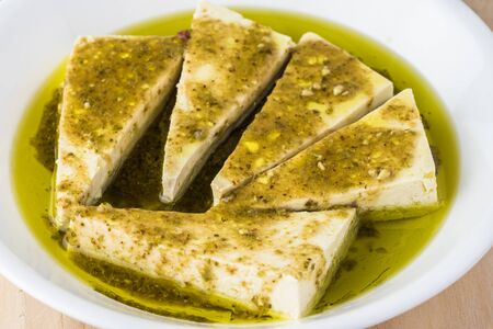 Cooking. Pieces of organic firm  tofu in marinanate sauce.