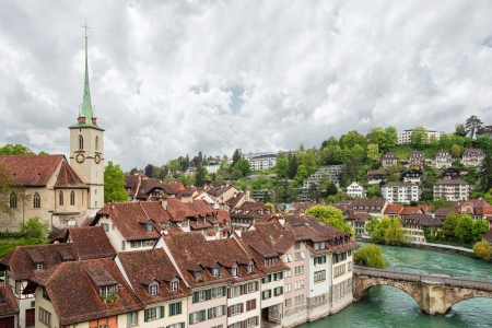 Church, bridge and houses with tiled rooftops, Bern, Switzerland.のeditorial素材