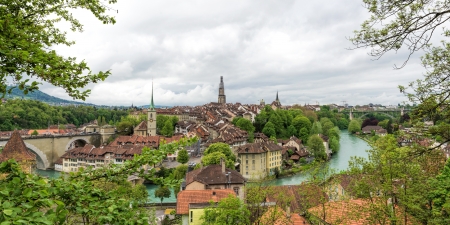 Church, bridge and houses with tiled rooftops, Bern, Switzerland.の写真素材