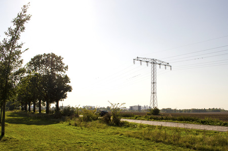 Power mast near a country road in the surrounding countryside of Berlin, Germanyの写真素材