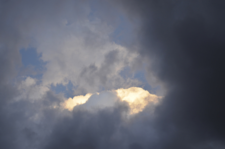 Stormy weather front 	illuminated from sun