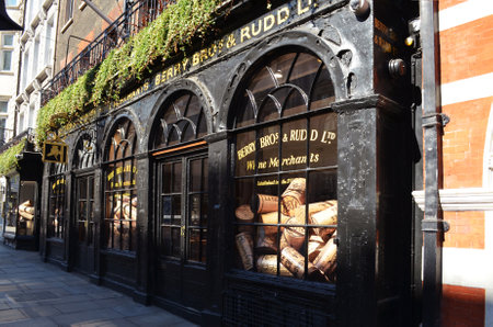 View to a historic alley with the shopwindow of Berry Bros. & Rudd with oversized wine corks - London, Great Britain - 08/02/2015のeditorial素材