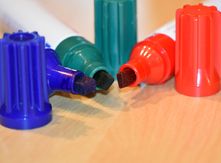 Closeup view to three felt tips of permanent markers in blue, red and green color, space for text at the bottom of the photoの写真素材