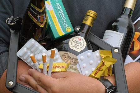 Berlin, Germany - May 11, 2018: Trapped in the legal and socially acceptable addiction by alcohol, cigarettes, tablets and sweetsのeditorial素材