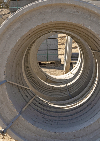 Looking through some big concrete rings on a construction siteの写真素材