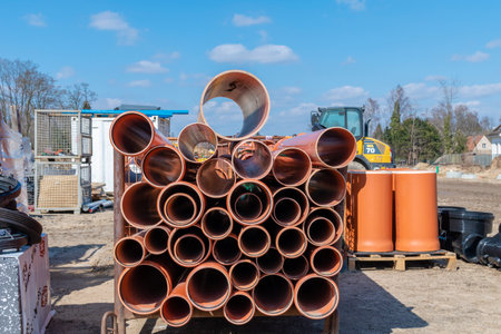 Berlin, Germany - April 2, 2018: Looking to plastic pipes on a construction site with material, containers and construction machineryのeditorial素材