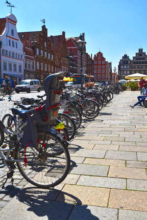 Lueneburg, Germany - June 5, 2018: View to the German medieval town of Lueneburg. You see the facades of bricks and small shops and a lot of bikes in a row.のeditorial素材