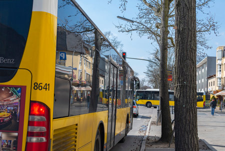 Berlin, Germany - April 02, 2018: Two typical Berlin busses on a rural shopping streetのeditorial素材