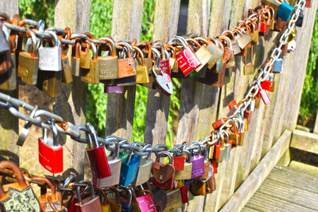Hitzacker, Germany - June 3, 2018: Countless, colorful love padlocks hanging on a railing at the...