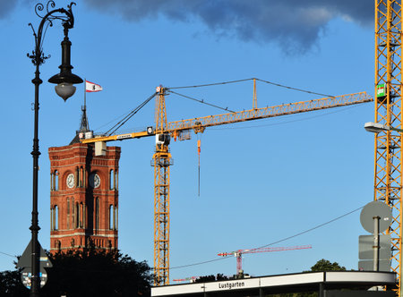 Berlin, Germany - June 30, 2018: View from the Lustgarten onto the tower of the Red Town Hall and a historic lantern in Berlin. You can also see cranes from the construction sites of downtown.のeditorial素材