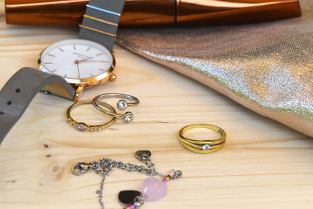 Berlin, Germany - May 25, 2018: Clock lying on a table with various trinkets and mascaraのeditorial素材