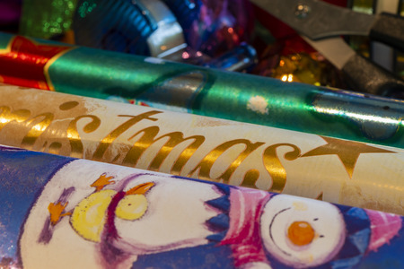 Various materials such as scissors, wrapping paper and ribbons to pack and decorate Christmas...