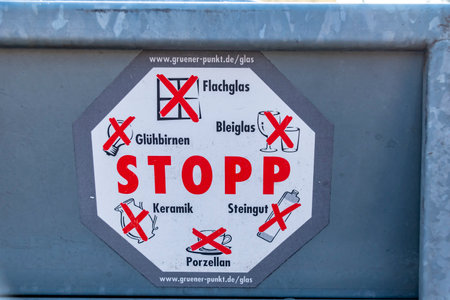 Berlin, Germany - January 22, 2019: Glass container from the Berlin recycling company on the roadside with stickers describing the rules for use.のeditorial素材