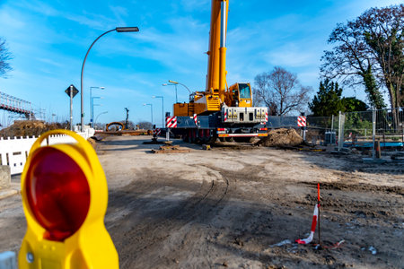 Berlin, Germany - January 19, 2019: Equipment of a construction site, on which the new railway line for the "Dresden railway" is built, with a large crane in the background.のeditorial素材
