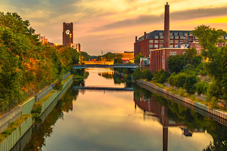 The Teltow Canal in Berlin-Tempelhof, Germany, overlooking bridges and old factory buildings in the light of the setting sun.のeditorial素材