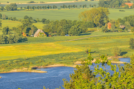 View over the Elbauen in Lower Saxony, Germany. You see a landscape with fields, meadows, trees and the river Elbe.の写真素材