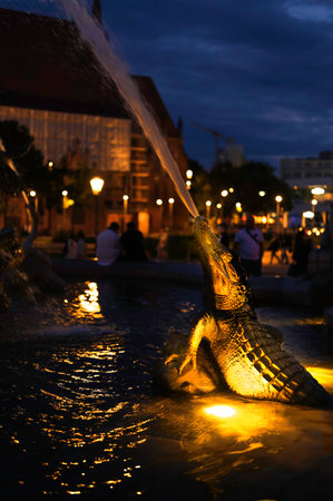 Berlin, Germany - August 3, 2019: Lighted statue in form of a crocodile in the historic Neptune's Fountain in the center of Berlin at night.のeditorial素材