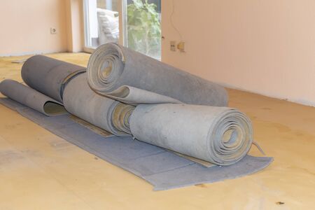 Carpet leftovers in a living room after being removed to lay a new floor covering.の写真素材