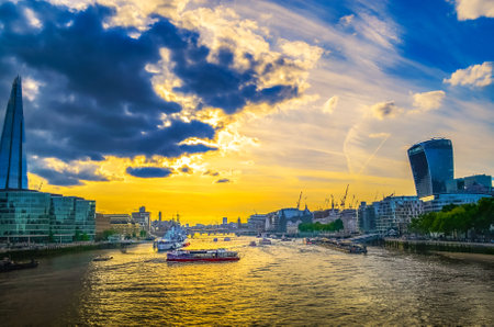London, Great Britain - August 1, 2015: Skyline of London with the river Thames, many different boats at the end of the day in the sunset.のeditorial素材