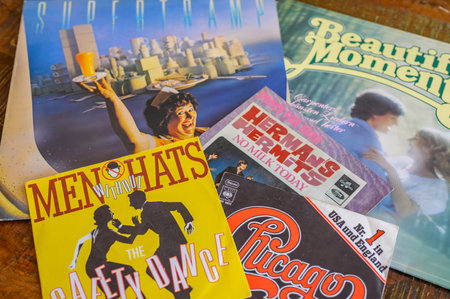 Berlin, Germany - August 25, 2019: Some record covers from the sixties to the eighties on a wooden table.のeditorial素材