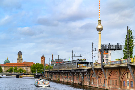 Berlin, Germany - September 16, 2019: Railway arcades at the river Spree in the center of Berlin. In the background you can see the Red Town Hall, the Alexander Tower and other sights.のeditorial素材