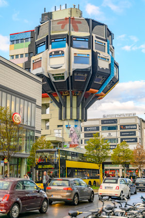 Berlin, Germany - October 5, 2019: Restaurant tower of the seventies from painted concrete in a business street in Berlin-Steglitz against blue sky.のeditorial素材