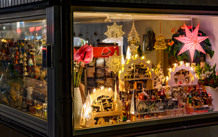 Bansin, Germany - September 13, 2019: Evening shop window with illuminated Christmas decoration in a small shop on the island Usedom in Germany.のeditorial素材