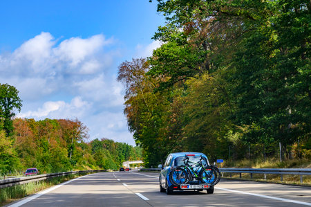 Freeway 11, Germany - September 12, 2019: Car on the freeway 11 with a bike carrier attached to the stern and two bicycles mounted on it.のeditorial素材
