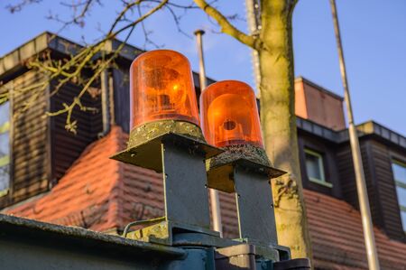 Building of a volunteer fire department in Berlin, Germany. In the foreground you can see focussed warning lights, which are warning people, if fire engines leave the fire station.の写真素材