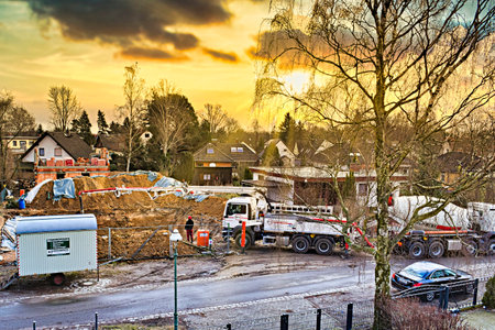 Berlin, Germany - March 9, 2018: Mobile concrete pump on a construction site at making the ground floor of a house in front of a wonderful sunset.のeditorial素材