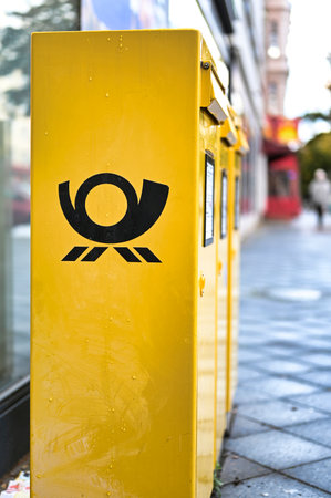 Berlin, Germany - October 5, 2019: Several mailboxes with the German Post logo in typical yellow on a sidewalk in Berlin, Germany.のeditorial素材