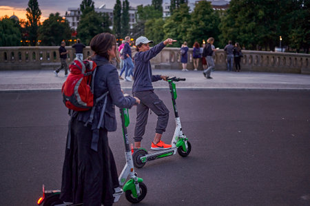 Berlin, Germany - August 3, 2019: Tourists traveling in the center of Berlin on electric scooters against the historical backdrop of the old town.のeditorial素材