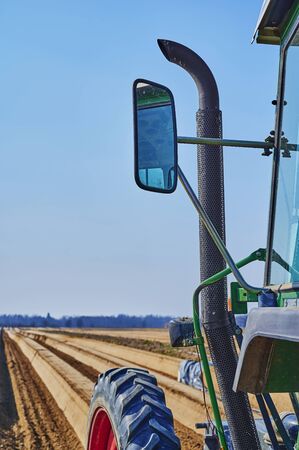 You look past a tractor at an asparagus field in Germany.の写真素材