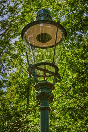 Historic street lamp that was powered by gas and stands in a Berlin park.の写真素材
