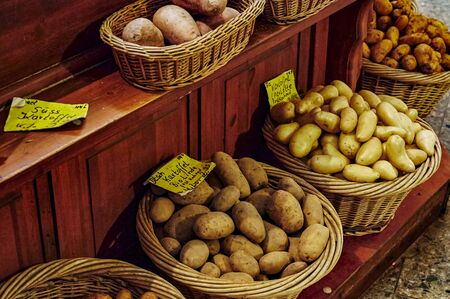 A market stall with different types of potatoes.の写真素材