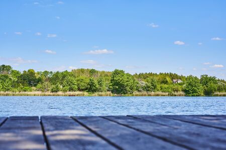 Blue and cloudy sky over a lake in the near of Sperenberg, Germany.の写真素材
