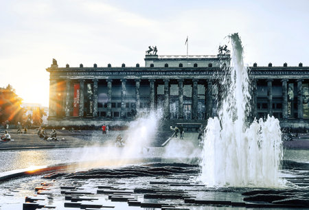 Berlin, Germany - June 17, 2019: You can see a fountain and people relaxing on a meadow near the Berlin Dome in the evening sun. In the background you can see the Old Museum.のeditorial素材
