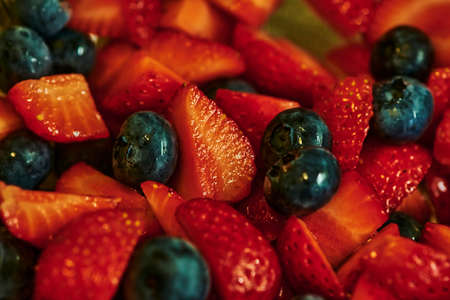Fresh strawberries and blueberries as ingredients for the vegan and healthy cuisine.