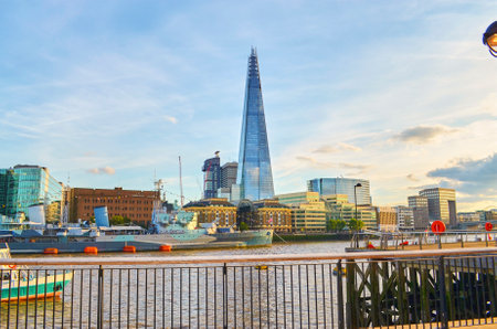 London, Great Britain - August 1, 2015: Cityscape at the Thames with the warship HMS Belfast and the skyline of London with the Shard at dusk.のeditorial素材
