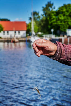Scene while fishing on a river in Germany with a bait held up.