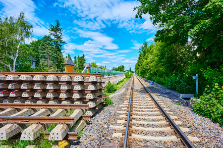 Berlin, Germany - May 29, 2020: Stack of concrete sleepers and rails on a construction site on a railway line in South Berlin.のeditorial素材