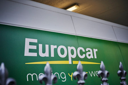 Berlin, Germany - February 21, 2020: View to the logo of a car rental company in downtown Berlin behind unfocused fence tips.のeditorial素材