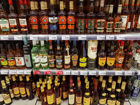 Berlin, Germany - January 25, 2021: View to a shelf with different bottles of alcoholic beverage in a supermarket.のeditorial素材