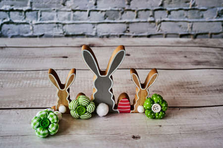 Three wooden Easter bunnies from behind with decoration.の写真素材