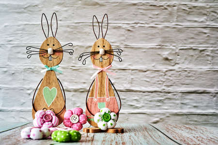 Two wooden Easter bunnies with decoration.の写真素材