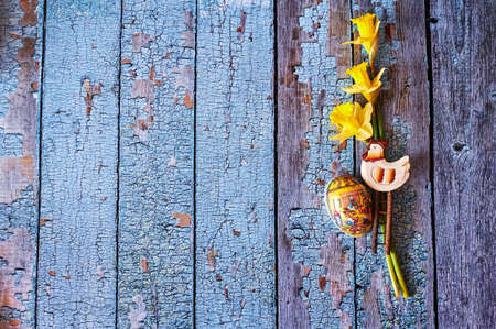 Three yellow jonquils with traditional Easter decoration.