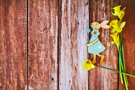 Wooden Easter bunny with flowers as decoration.の写真素材
